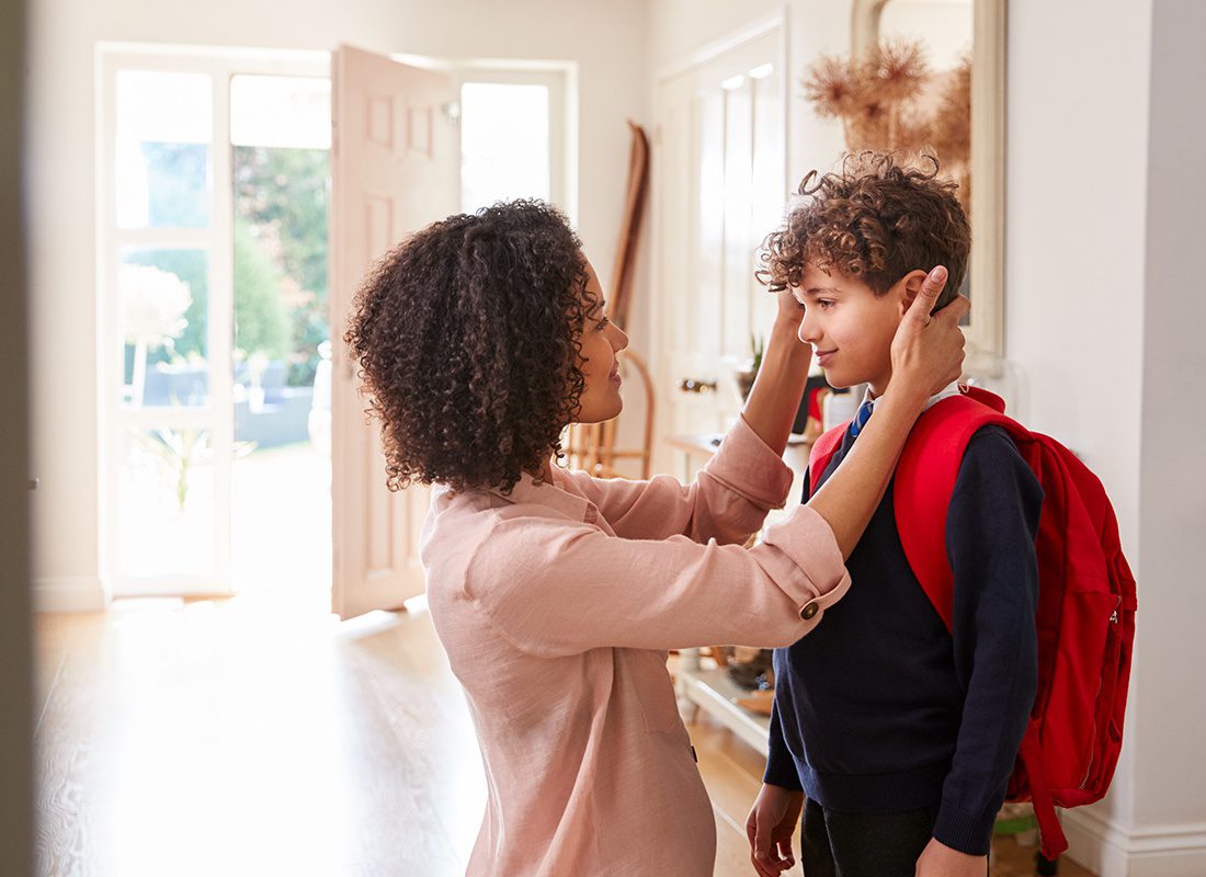Personal Insurance - Mother Helps Her Son Get Ready to Leave the House for School