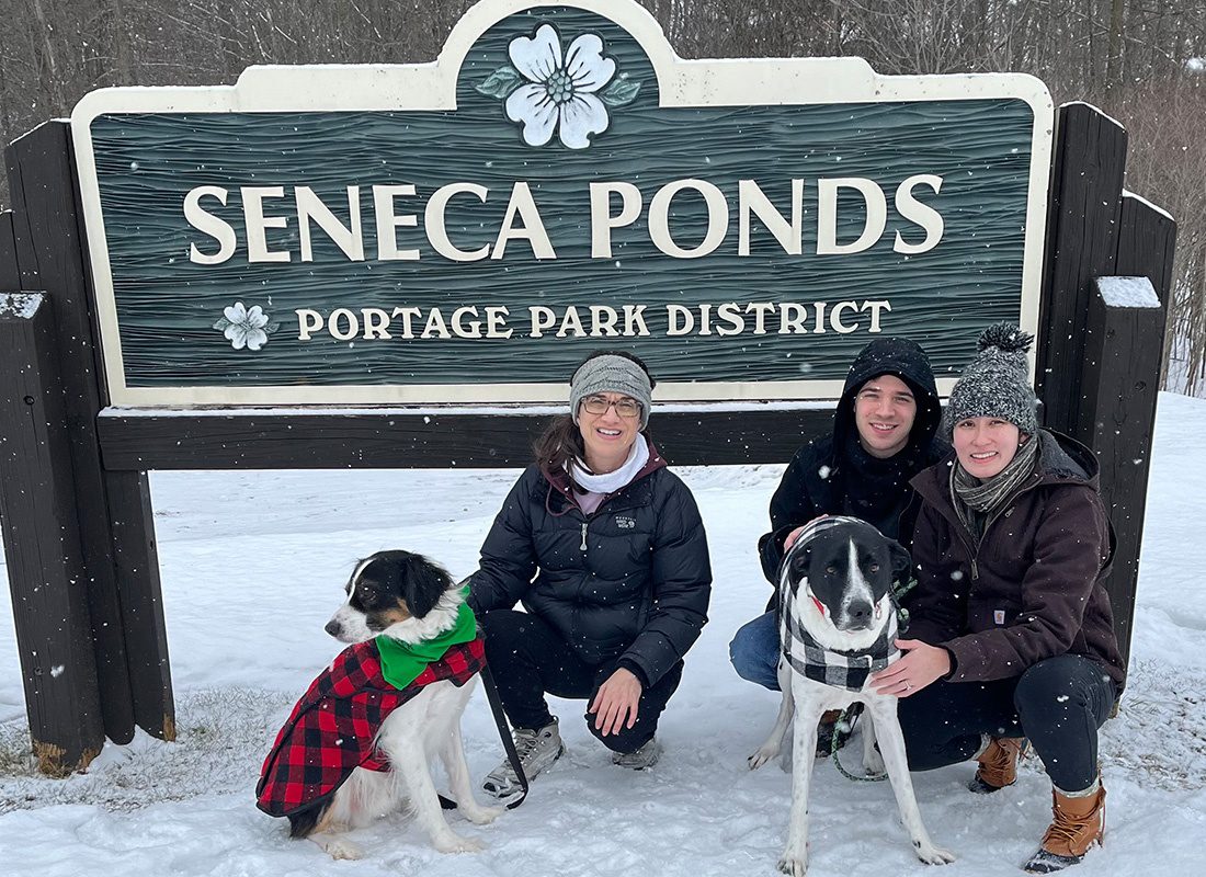 Casual Team Photo - Brimfield Insurance Group Team Members Kneeling Together at Seneca Ponds on a Snowy Day